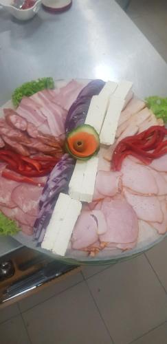 a plate of food with meat and vegetables on it at Mai Danube in Eşelniţa