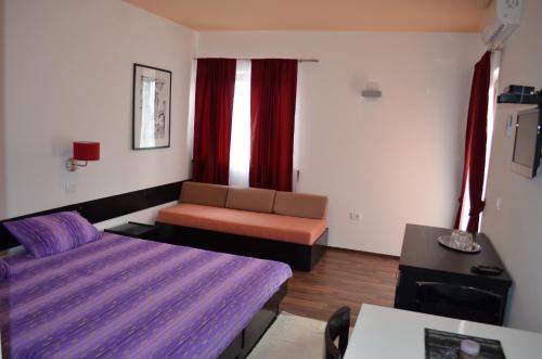 a hotel room with a bed and a couch at B&B Morena in Labin