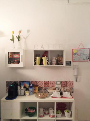 a shelf with cups and other items on a wall at B&B IL POETA in Palermo