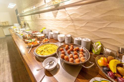 a buffet with many bowls of food on a table at Hotel Rügenblick in Stralsund