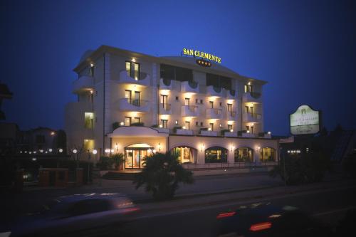 a lit up building with a sign on it at night at Hotel San Clemente in Santarcangelo di Romagna