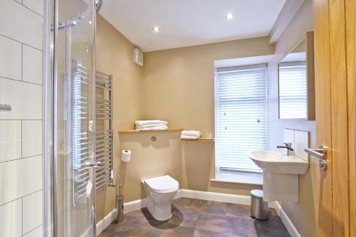 a bathroom with a toilet and a sink and a shower at 1885 the Venue - Pub, Restaurant, Rooms & Function House in Halifax