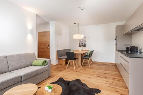 a living room with a couch and a table at Skylodge Alpine Homes in Haus im Ennstal