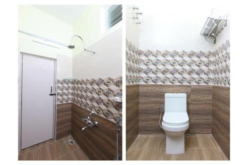 a bathroom with a toilet and a shower at Hotel Ramcharan Residency, Tirupati in Tirupati