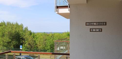 a sign on the side of a building that reads italian voice at Baltic Park Plaza by Baltic Home in Świnoujście