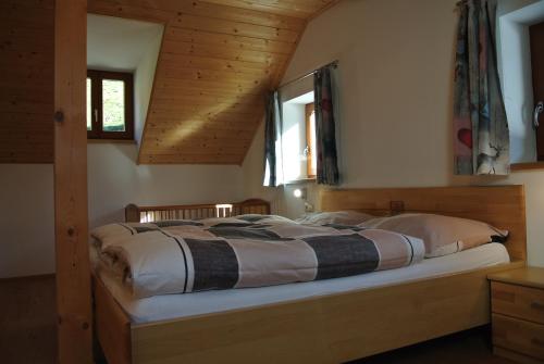 a bedroom with a large bed in a wooden room at Bio-Bergbauernhof Möslhof in Aigen im Ennstal
