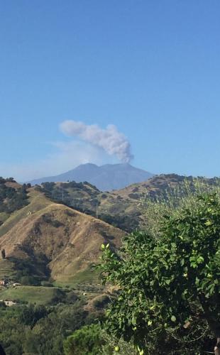 a view of a mountain range with a tree at Don Vittorio Country Village in Taormina
