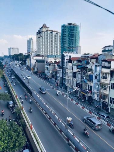 a busy highway in a city with cars and buildings at The Royal Hotel Near West Lake in Hanoi