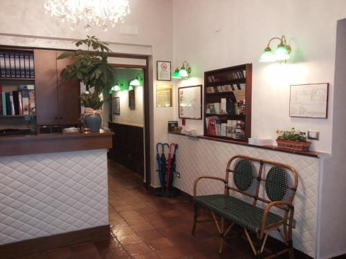 a restaurant with two chairs and a counter in a room at Hotel al Corso in Legnano