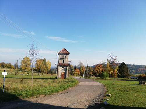 a small tower on the side of a road at Apartmány Na Rozcestí in Lomnice nad Popelkou