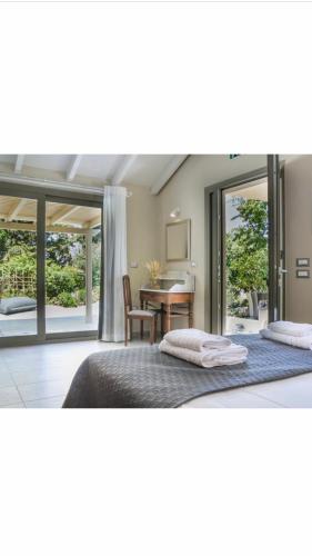 a bedroom with two beds and a table with a desk at Fanari House in Argostoli
