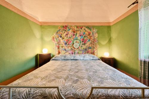 a bedroom with a bed with a colorful head board at Splendido rustico nella Langa in Clavesana