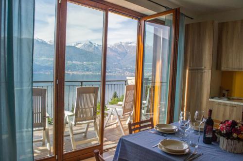 a dining room table with a view of the mountains at Residence Dorio in Dorio