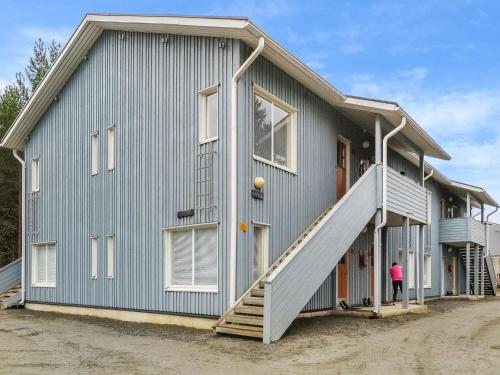 a house with a staircase on the side of it at Holiday Home Kanerva 202 by Interhome in Äkäslompolo
