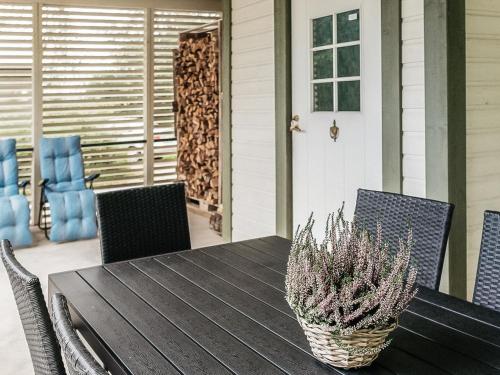 a table with chairs and a potted plant on a porch at Holiday Home B by Interhome in Porvoo