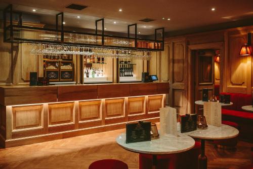 a bar with two tables in a room at The Scotsman Hotel in Edinburgh
