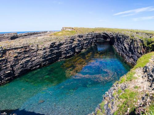 a cave in the side of a cliff at Apartment Kilkee Bay-1 by Interhome in Kilkee