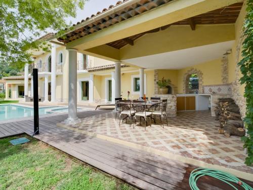 an outdoor patio with a table and chairs at Villa Caliopa by Interhome in Grasse