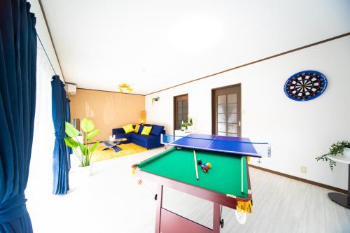 a living room with a pool table in it at Yokkaichi egaosakuie in Shimizucho 1 in Yokkaichi