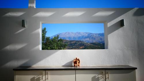 a mirror on a wall with a view of a mountain at Galini Breeze in Agia Galini