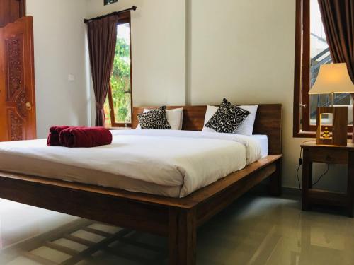 a bedroom with a bed and a window at Wina Ubud B&B in Ubud