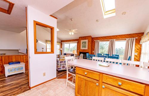 a kitchen and dining room with a table and chairs at Misty Blue in Corolla
