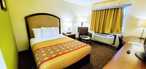 a hotel room with a large bed in a room at Travel Inn and Suites- Sikeston Miner I-55 exit-67 in Sikeston