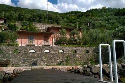a stone wall with a building in the background at Villa sul Lago con pontile privato a Brenzone sul Garda - Unique and exclusive in Brenzone sul Garda