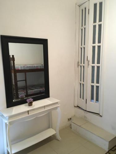 a mirror sitting on a white table in a room at Augusta Jardins Home in Sao Paulo
