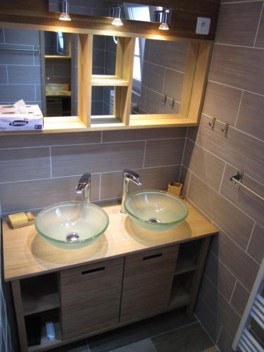 a bathroom with two sinks on a counter at La Saline in Le Palais