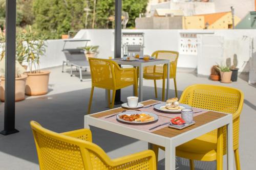 a table and chairs with food on a patio at Villa Nestor in Ingenio