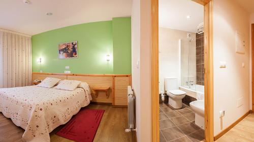 a bedroom with a bed and a bathroom with a toilet at Hotel San Briz in A Pontenova