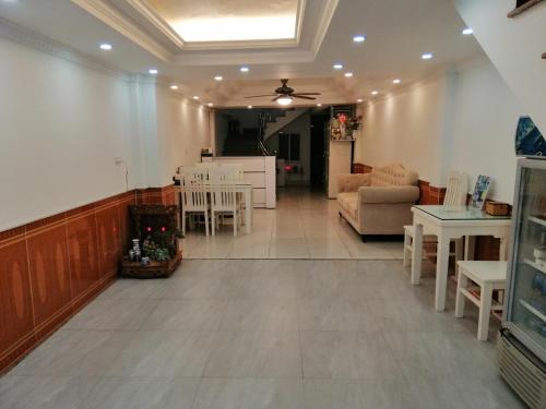 a living room with a couch and a table and chairs at Roma Hotel Noi Bai airport in Hanoi