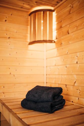 a stack of towels sitting on a table in a sauna at Domek Aleksander z basenem, banią ruską i sauną in Sulęczyno