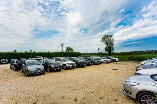 a row of cars parked in a parking lot at Annia Park Hotel Venice Airport in Tessera