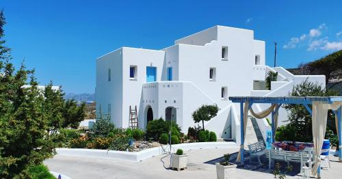 a white building with a blue sky in the background at Sarakiniko Rooms in Adamas