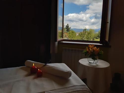 a room with a table with a candle and a window at B&B Il Girasole in Camigliatello Silano