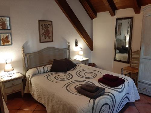 a bedroom with a large bed with two towels on it at Casa Graciano II in Ochagavía
