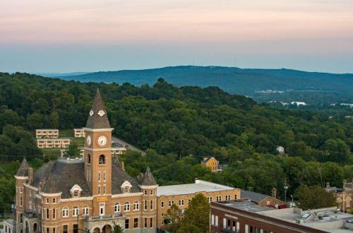 a building with a clock tower on top of it at Graduate by Hilton Fayetteville, AR in Fayetteville