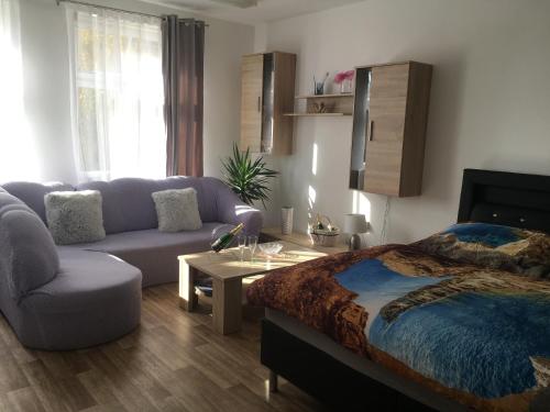 a living room with a bed and a couch at Cecilka in Náchod