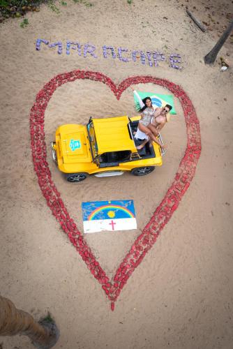 a picture of a heart written in the sand at Hotel Aconchego Porto de Galinhas in Porto De Galinhas
