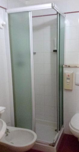 a bathroom with a shower with a toilet and a sink at Hotel Sole in Passo del Tonale