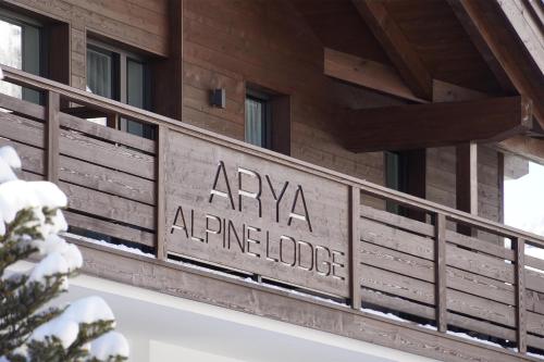 a sign on the side of a building at Arya Alpine Lodge in Selva di Val Gardena