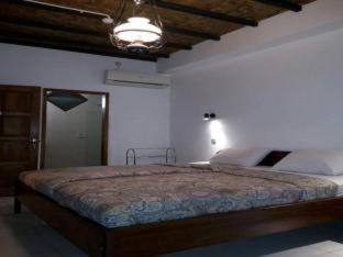 a bedroom with a large bed in a room at Bladok Hotel & Restaurant in Yogyakarta