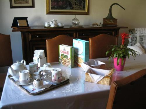 a table with a tea set on top of it at La casa dei pini in Malnate