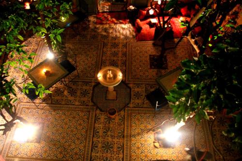 an overhead view of a table with lights and a clock at Riad Al Nour in Marrakech