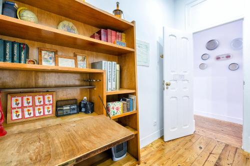 a room with wooden shelves filled with books at Donapart in Lisbon