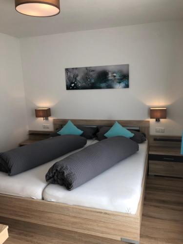 a bed with two pillows on it in a room at Haus Fuetsch in Virgen