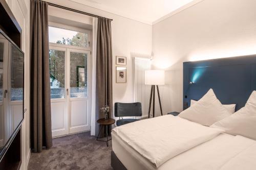 a hotel room with a bed and a window at Villa Rein Boutiquehotel in Bad Reichenhall