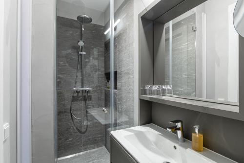 a bathroom with a shower and a white sink at Villa Rein Boutiquehotel in Bad Reichenhall